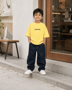 Boys oversized graphic t-shirt in pastel yellow, Good Kid Bad Ideas print, Bold Cub Korean streetwear - lifestyle shot