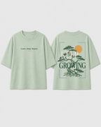 Boys oversized graphic t-shirt in sage green, Keep Growing print, Bold Cub Korean streetwear - flat lay