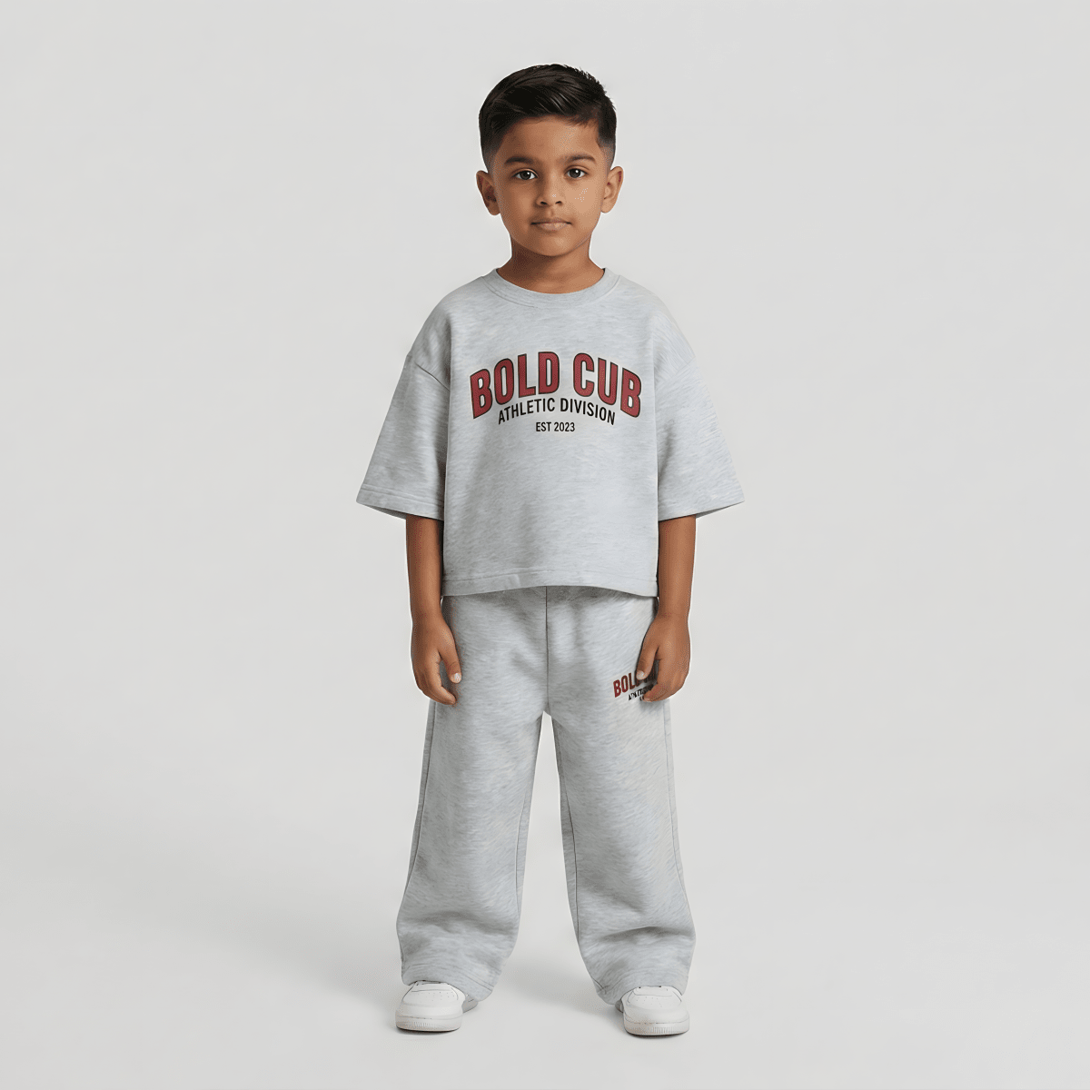 Child wearing a gray outfit with 'BOLD CUB' text on a white background