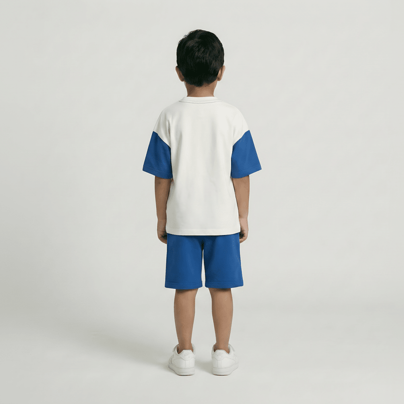 Child wearing a white and blue outfit on a plain background